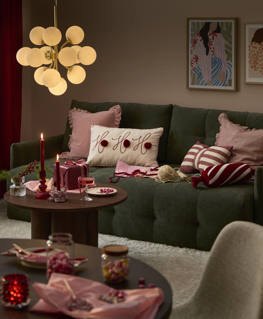 en grön bäddsoffa i ett julpyntat hem