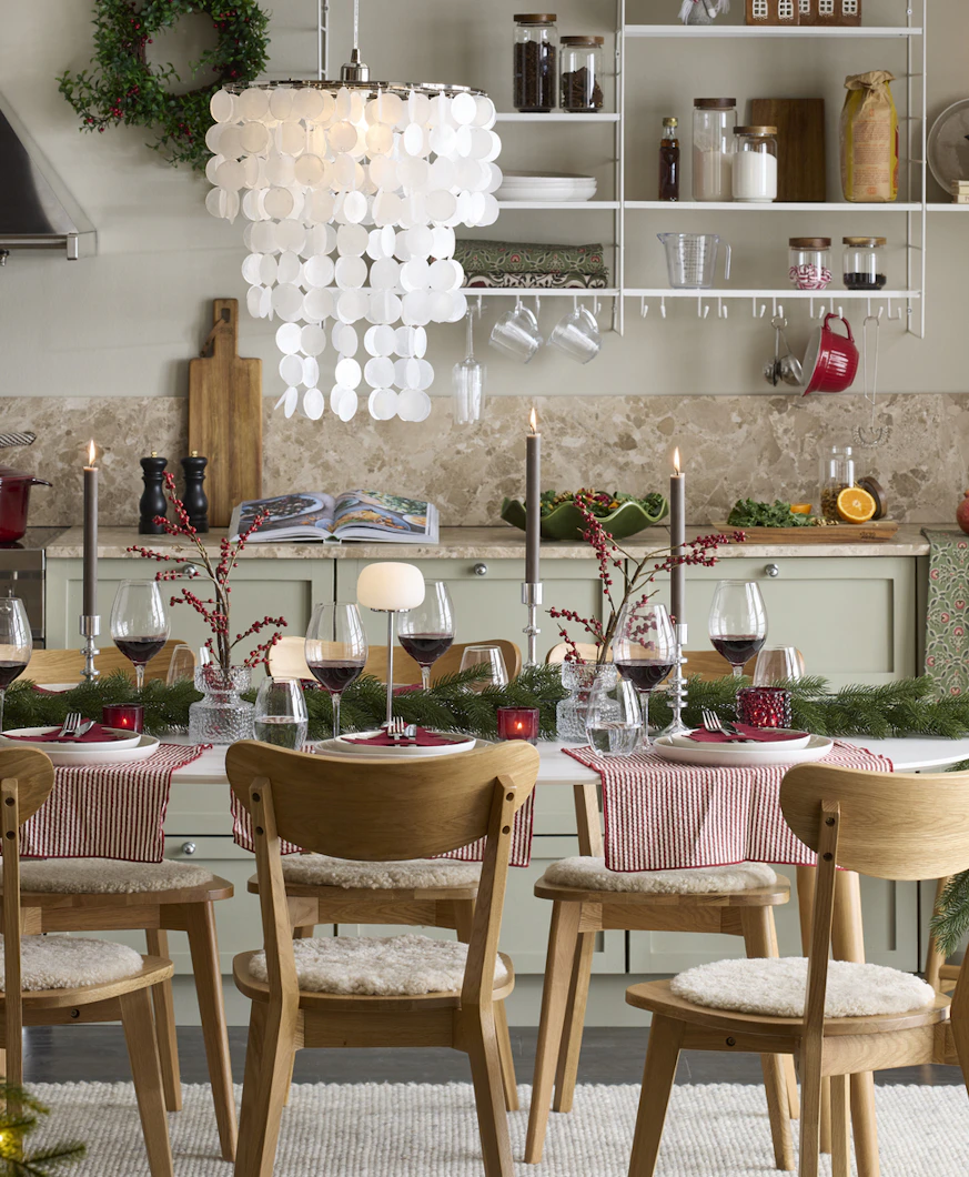 ett kök med julpynt och ett stort matbord med stolar