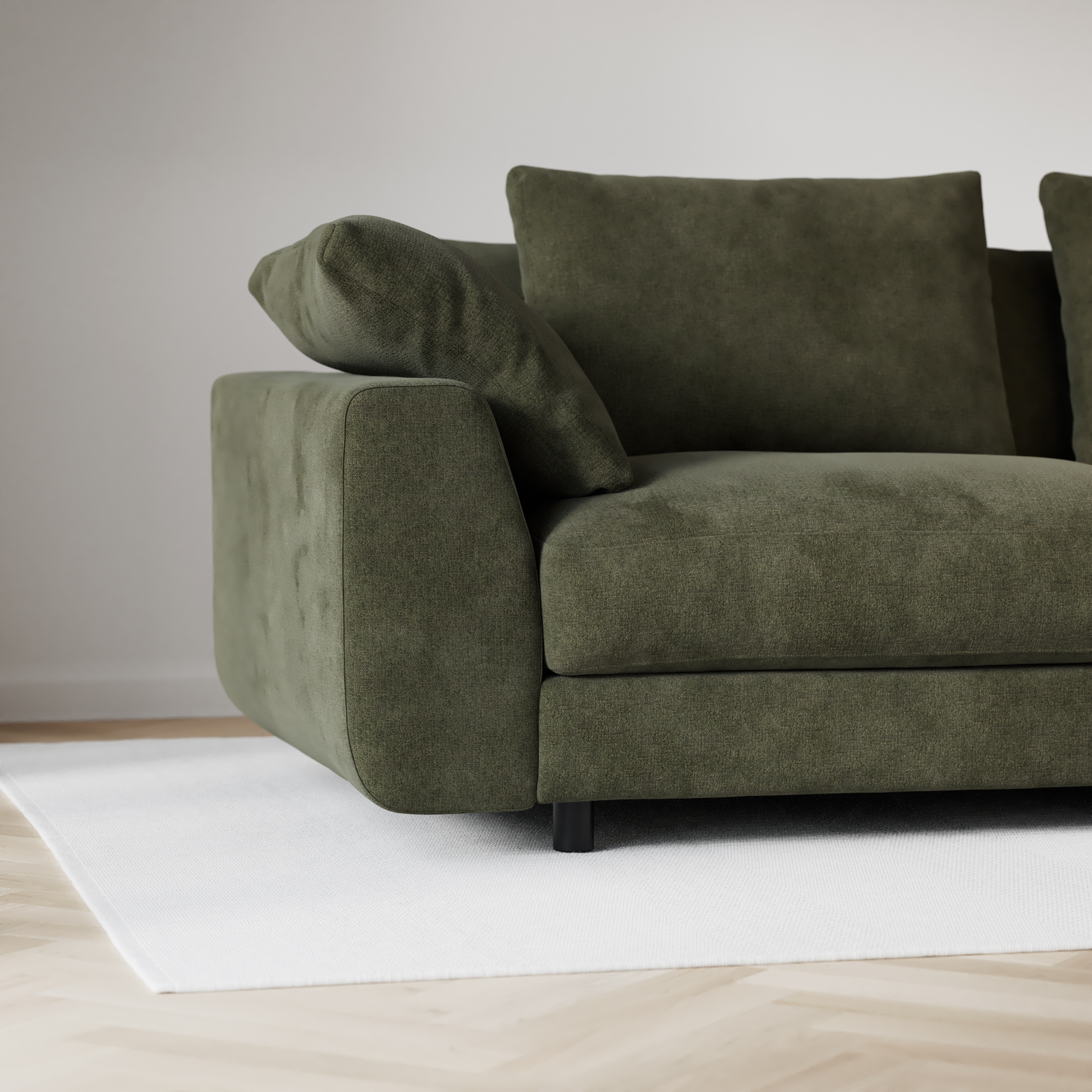 Närbild på soffans armstöd med rundade, mjuka hörn