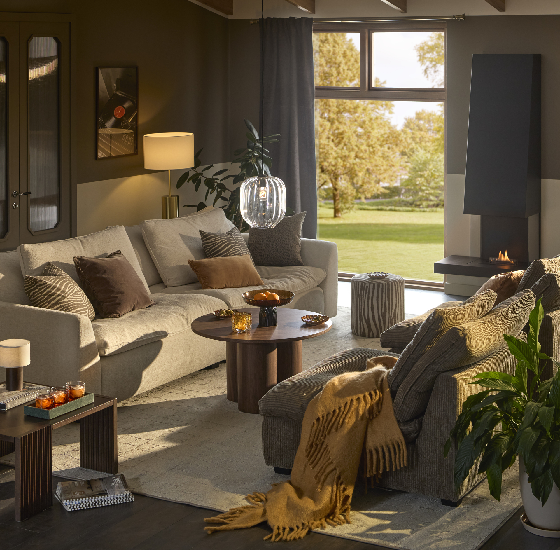 I ett stilrent vardagsrum står en vit soffa mitt emot två gröna soffmoduler i manchester