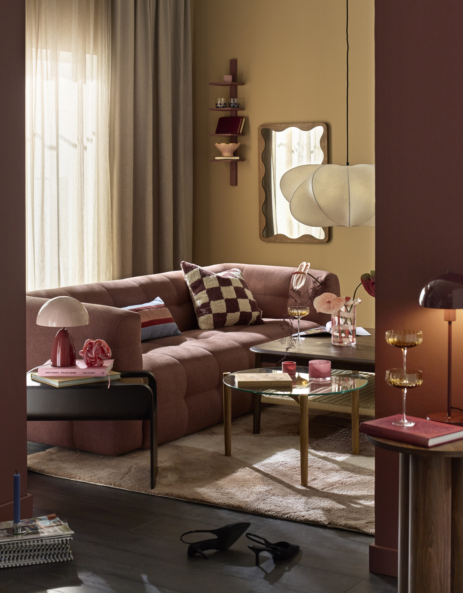 I ett gult vardagsrum står en rostfärgad soffa i modern design