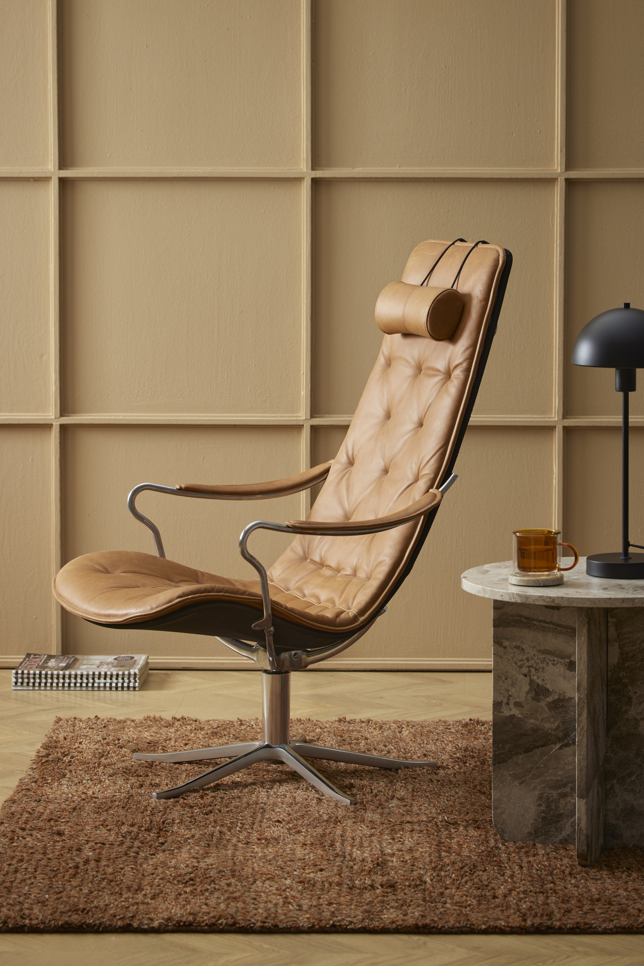 En brun läderfåtölj i modern retrodesign står i ett gult rum