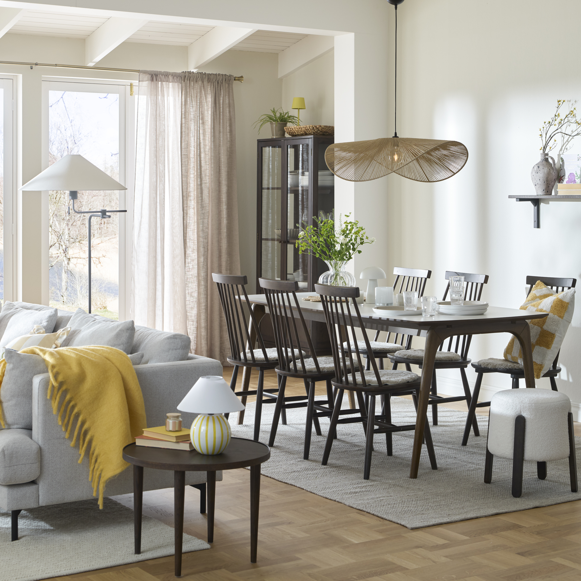 En stor lampa i organisk for hänger över ett matbord